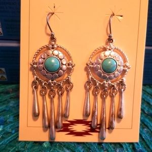 Dangling silver dream catchers with turquoise center. 2.5 inches in length.